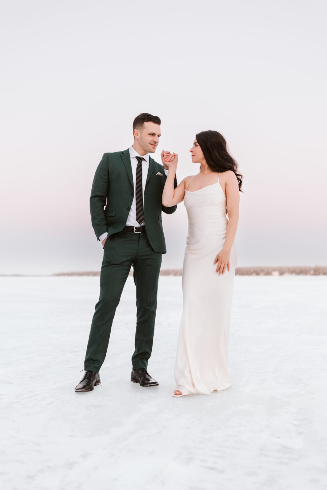 Small wedding winter in Ontario. Bride and Groom on ice in Ontario. photographer Mary Zita Payne who photographs winter weddings in the Kawartha Lakes