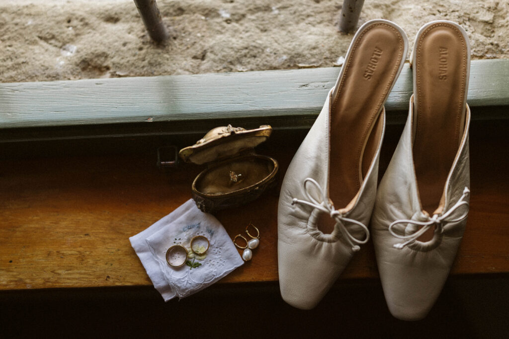 Elegant bridal shoes and vintage grandmother’s jewelry box detail photographed at Villa Olimpia in Tuscany,